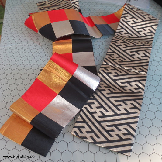 Sayagata, schwarz rot gold Hanhaba Obi, Seide mit Lurex